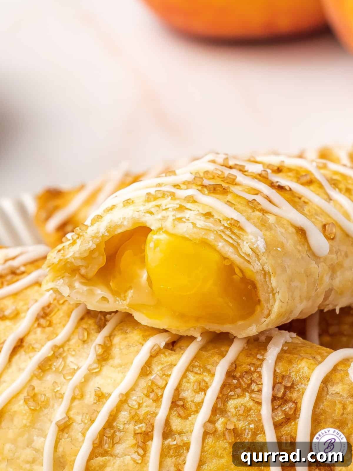 close up peach hand pie with bite taken