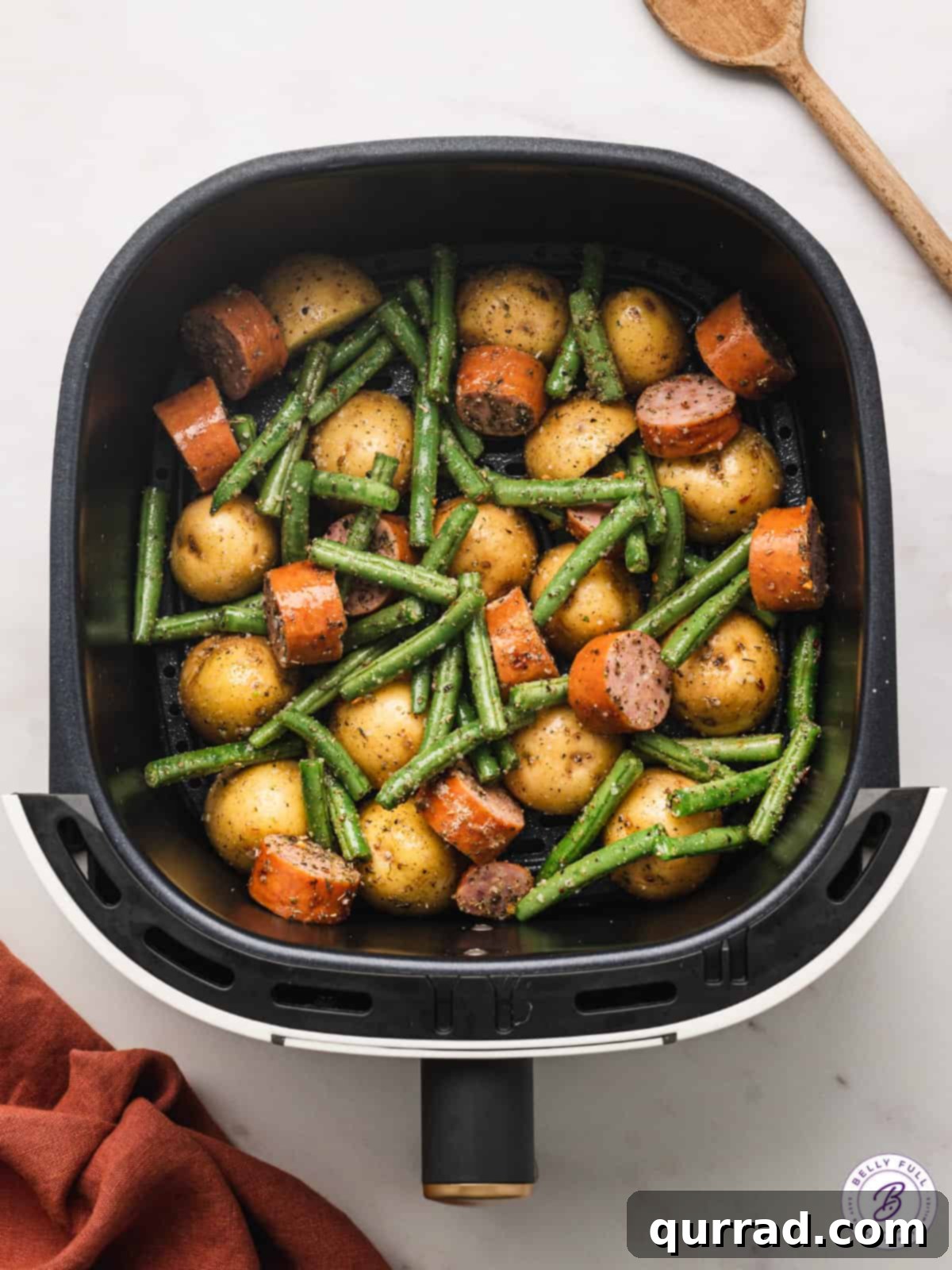 air fryer kielbasa and veggies inside air fryer basket