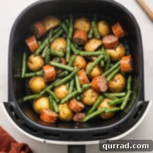 air fryer kielbasa and veggies inside air fryer basket