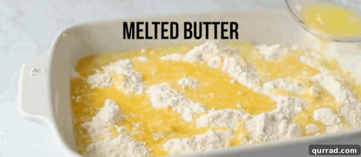 Lazy Peach Cobbler 5 Peach pie filling in a baking dish covered with an even layer of dry cake mix, and melted butter being drizzled over the top.