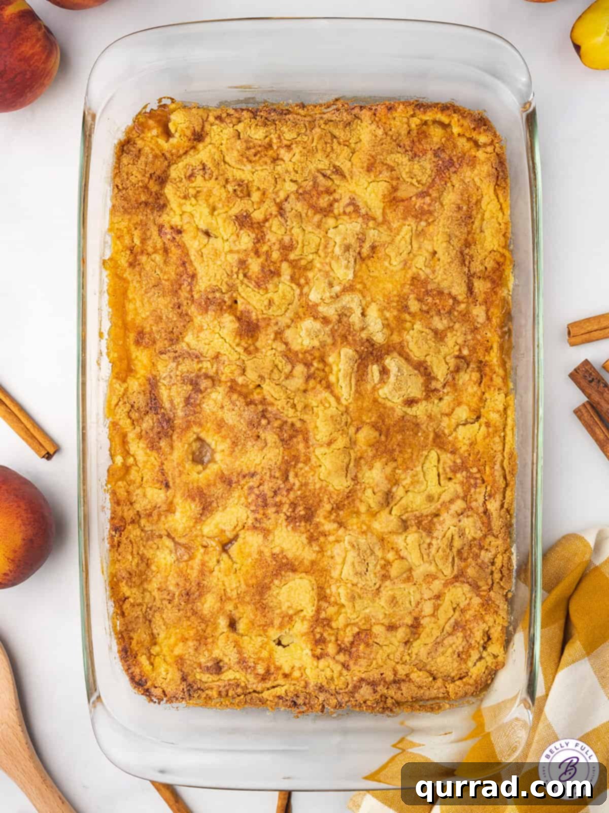 Lazy Peach Cobbler 7 An overhead view of a full 9x13 inch baking dish of golden-brown Peach Dump Cake, still warm from the oven.