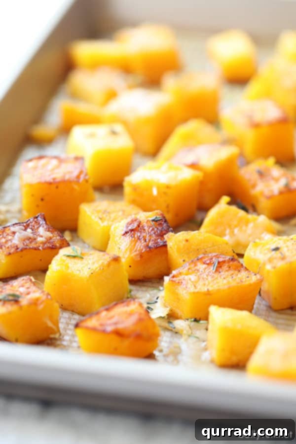 Golden Autumn Butternut Comfort 3 Freshly roasted butternut squash cubes on a baking sheet, ready for soup.