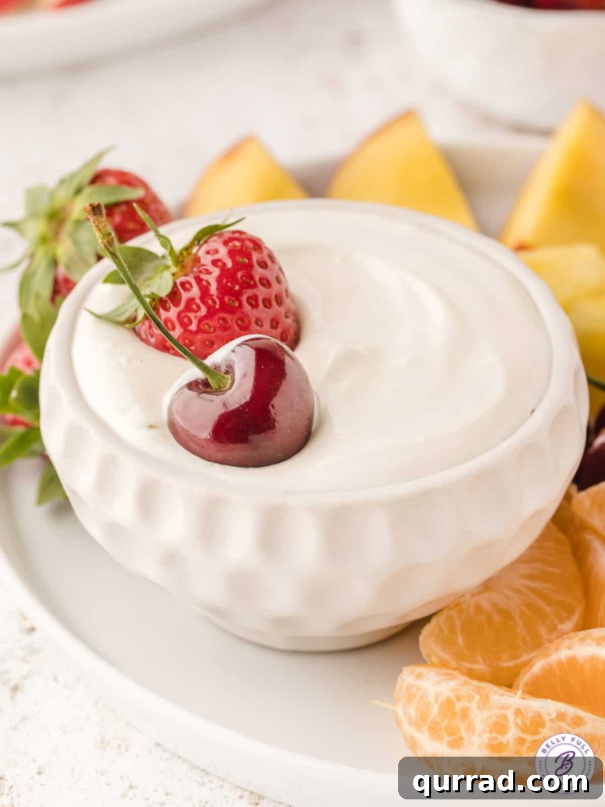 Creamy Fruit Delight 3 whole strawberry and cherry sitting in fruit dip