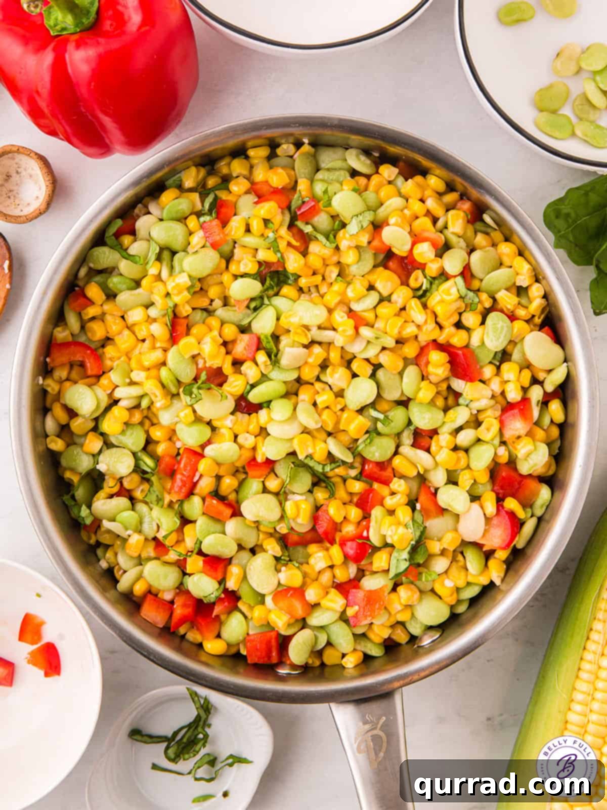 Made with corn, lima beans, and red bell pepper, Corn Succotash is ready in less than 15 minutes. An easy side dish for summer! Corn succotash ingredients simmering in a skillet, vibrant and fresh