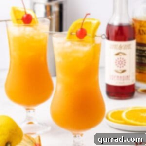 A hurricane cocktail garnished with an orange slice and cherry