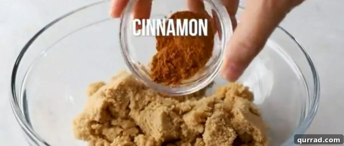 Combining cinnamon and brown sugar in a bowl to create the swirl mixture.