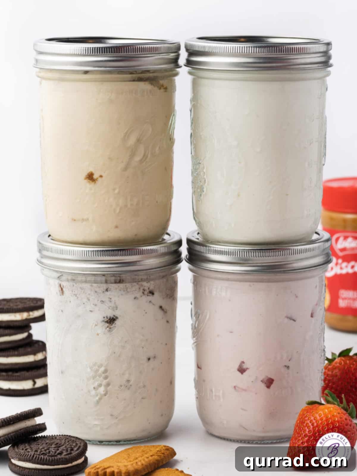 Homemade Jar Ice Cream Bliss 3 Four stacked glass jars, each containing a different flavor of vibrant ice cream, showcasing the versatility of mason jar desserts.