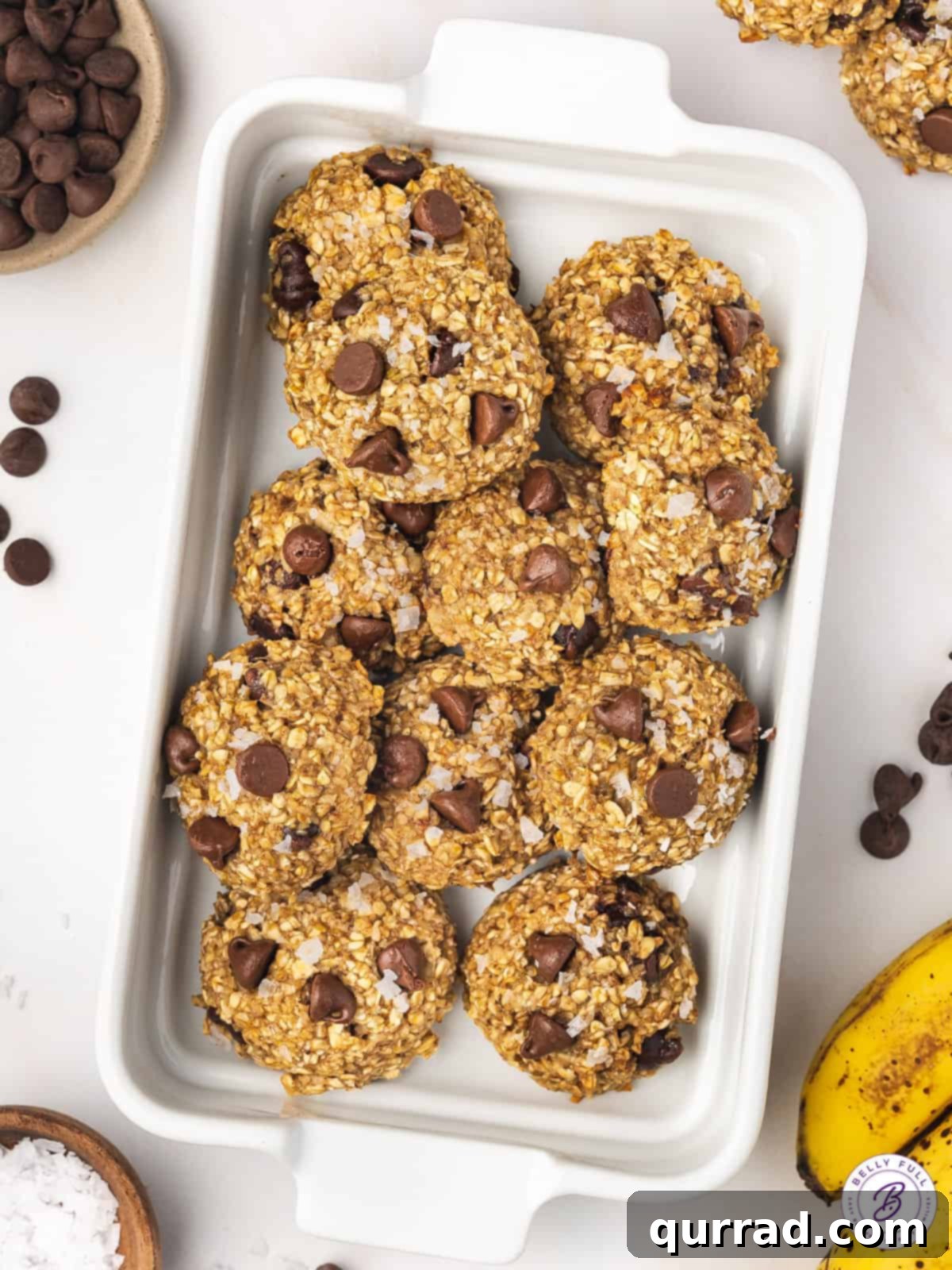 Freshly Baked Banana Oatmeal Cookies on a Tray An overhead view of a baking sheet filled with freshly baked banana oatmeal cookies, golden at the edges.