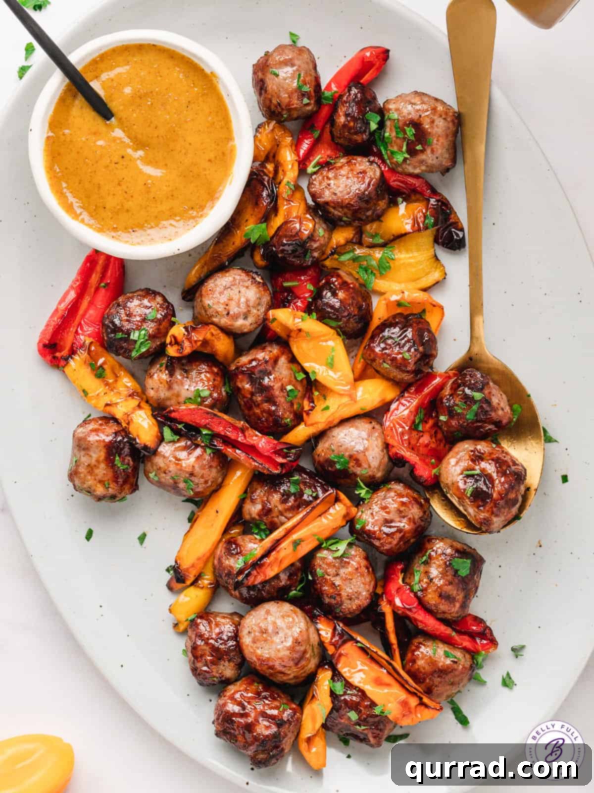 A vibrant overhead shot of perfectly cooked air fryer bratwurst and peppers, artfully arranged on a serving platter.