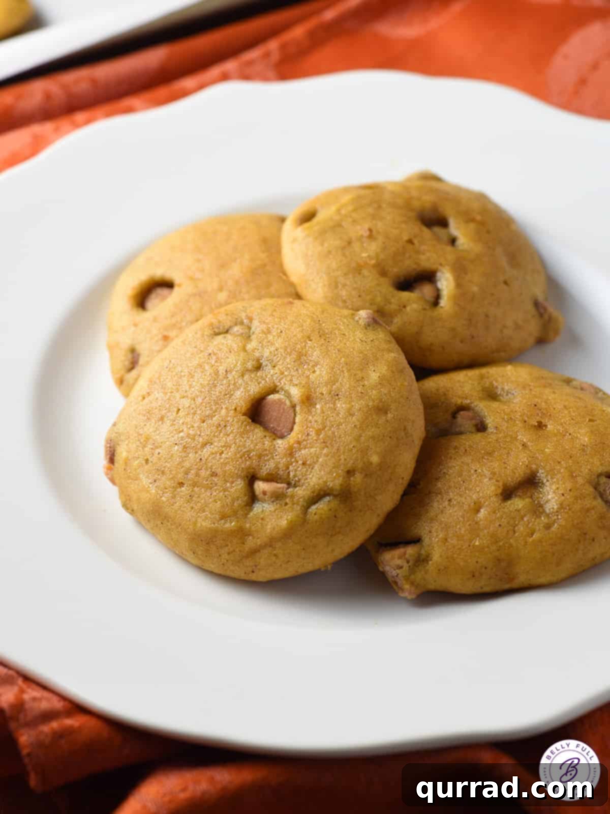 Butterscotch Pumpkin Spice Cookies 3 Soft pumpkin cookies arranged neatly on a white plate, ready to be enjoyed.