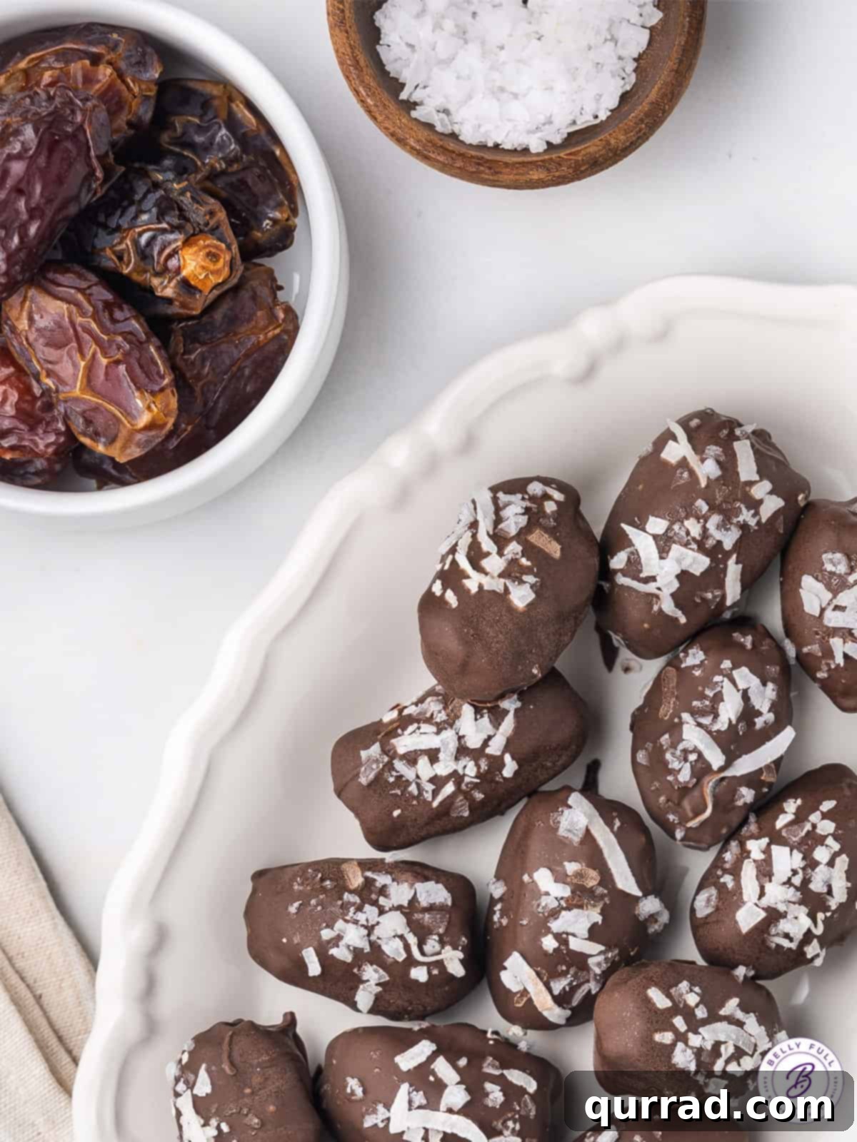 These healthy Almond Stuffed Dates deliver the exact taste profile of an Almond Joy candy bar, making them a delightful and guilt-free treat. An inviting overhead shot of perfectly crafted almond joy stuffed dates, artfully arranged on a tray, showcasing their irresistible appeal.