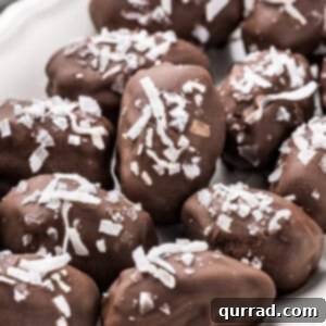 Almond Coconut Bliss Bites 2 Chocolate covered dates with coconut on a tray