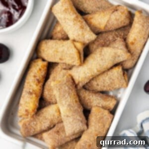 Overhead view of cherry cheesecake egg rolls in a baking dish