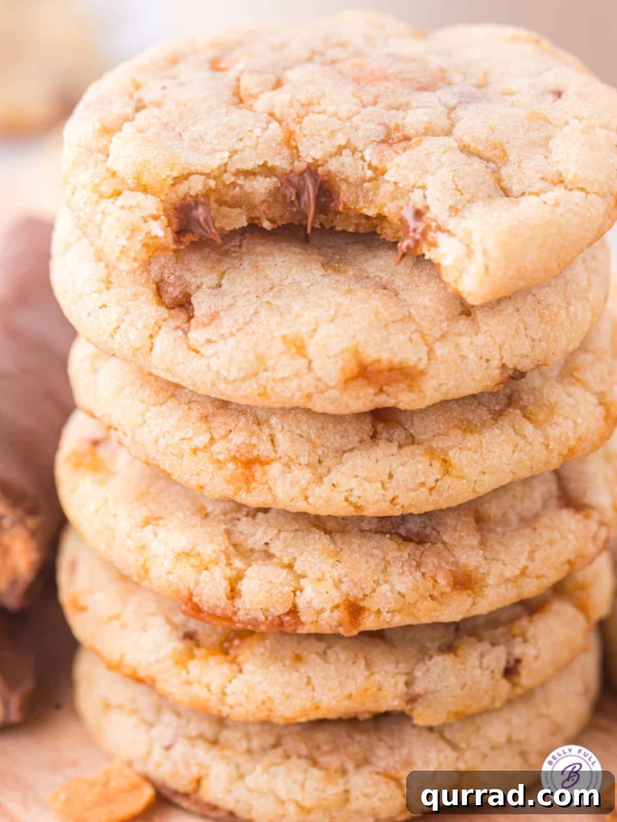 A stack of butterfinger cookies, one with a bite missing