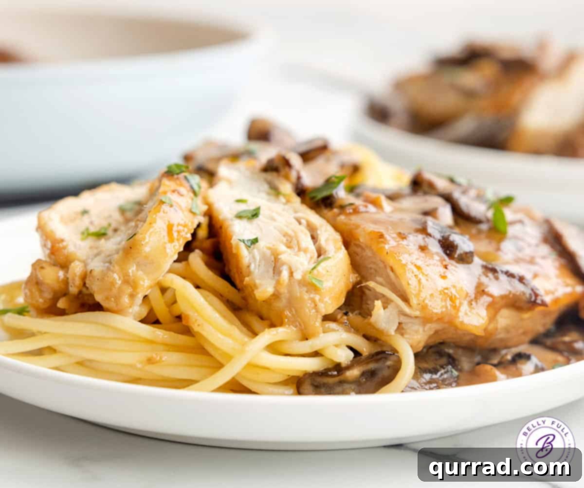 Sliced chicken marsala and spaghetti on a plate.