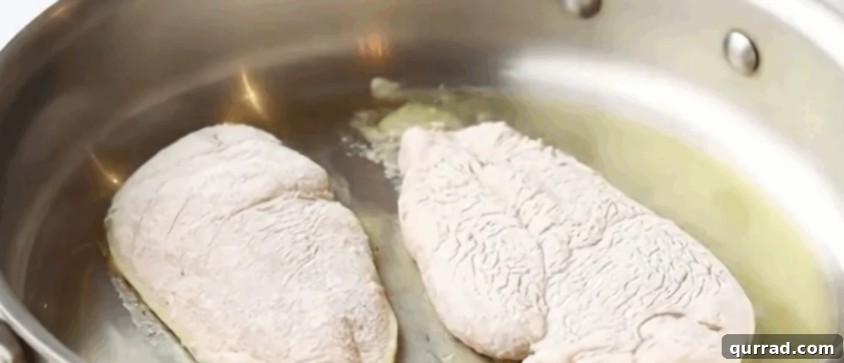 Cooking the seasoned chicken in a skillet. 