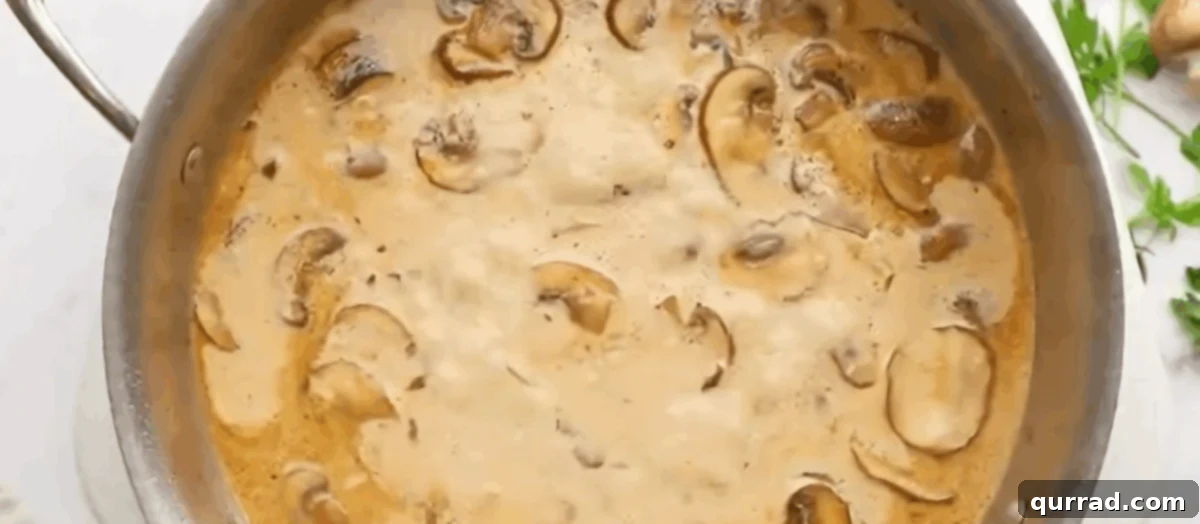 The mushroom sauce simmering in a pan.