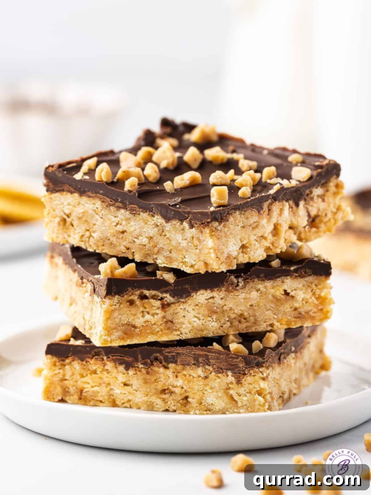 A stack of golden brown Ritz cracker toffee bars with a visible chocolate layer.