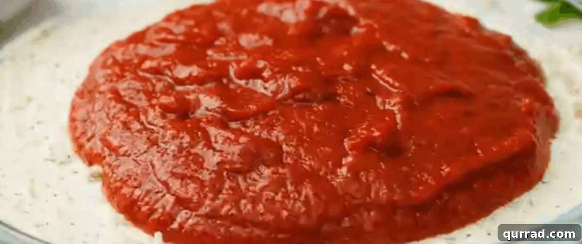 Hot Pizza Dip 4 Layering the rich pizza sauce over the creamy cheese base.