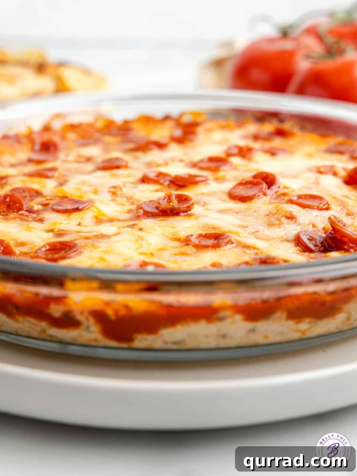 Made with just 5 ingredients (three of which are cheese!), this Pizza Dip is a party appetizer everyone will enjoy! Easy & cheesy! Pepperoni pizza dip in a round glass baking dish, ready to be served or stored.