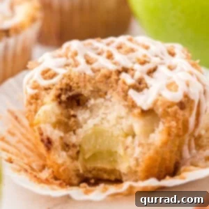 Spiced Apple Crumble Muffins 3 A perfectly baked apple streusel muffin with a golden streusel topping, ready to be glazed.