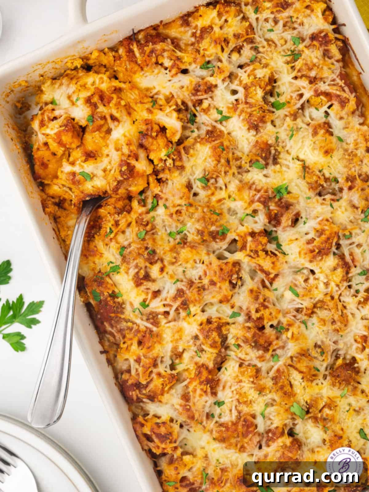 Easy Chicken Parmesan Casserole: Quick & Cheesy Weeknight Meal Overhead view of a golden brown and bubbly Chicken Parmesan Casserole