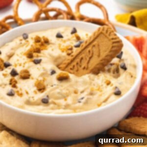 A bowl of cookie butter dip with a Biscoff cookie in it