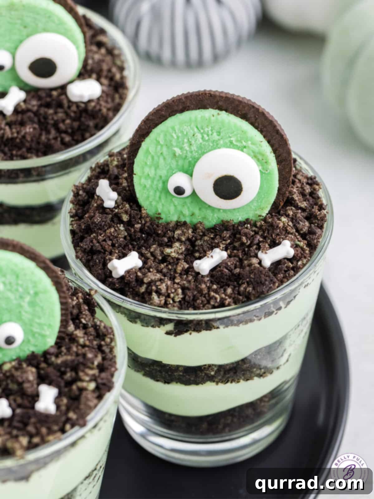 A single zombie dirt pudding cup with candy eyes and sprinkles, on a dark background.