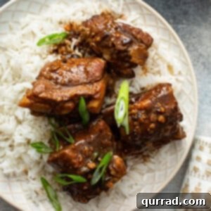 Sweet and Sticky Chinese Ribs 3 small Chinese pork ribs over rice with sauce and diced scallions