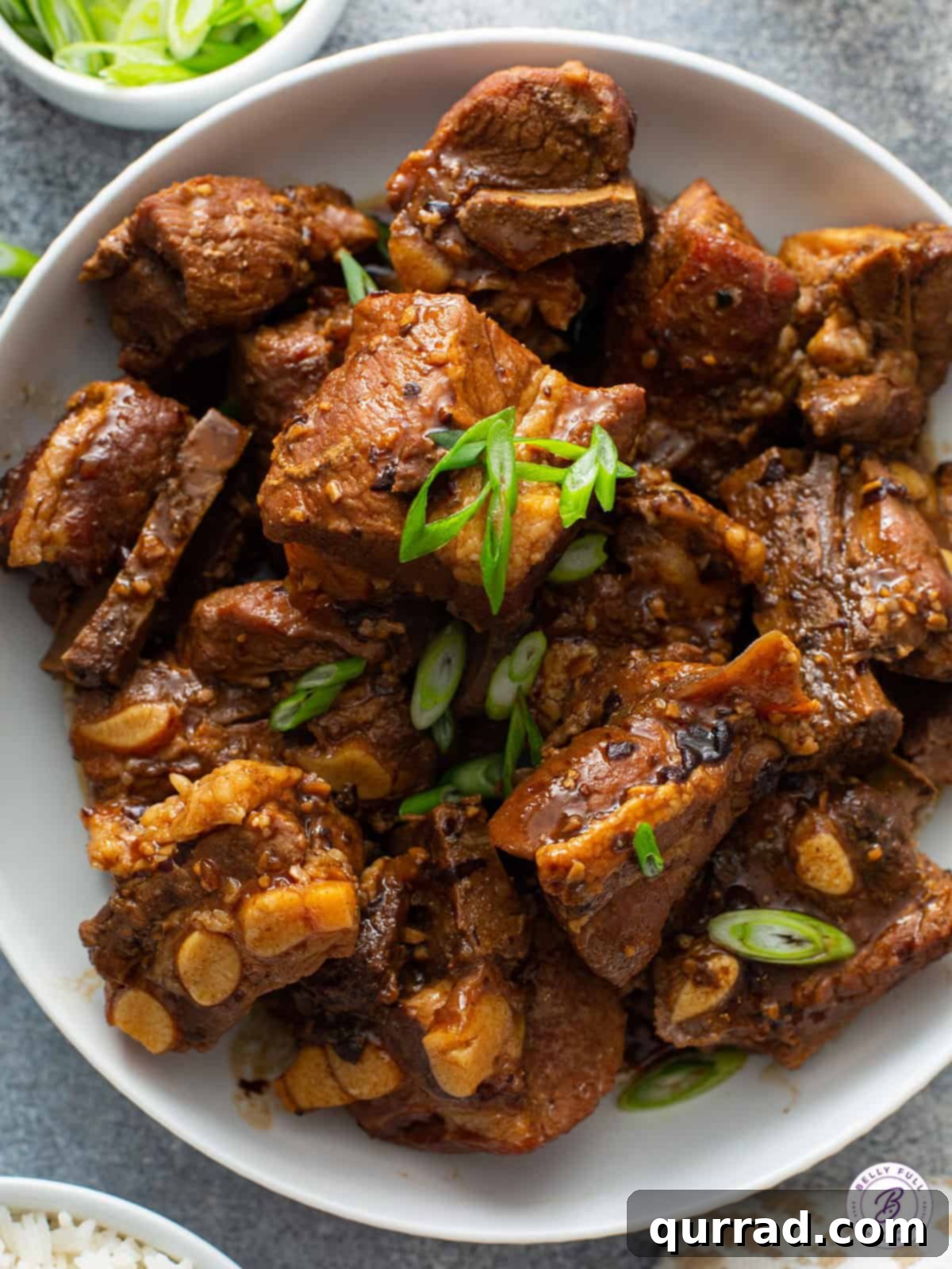 Sweet and Sticky Chinese Ribs 4 close up overhead Chinese pork spare ribs in a bowl with diced scallions