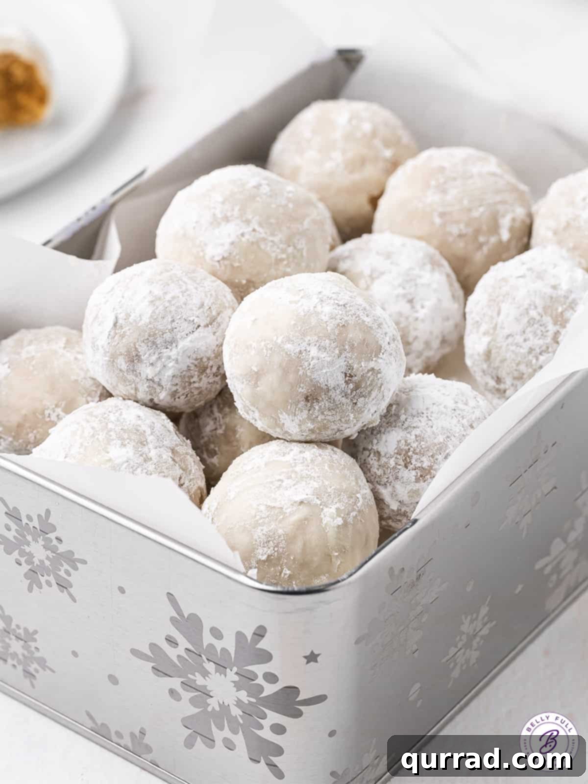Festive Gingerbread Truffles 2 A festive holiday gift box brimming with powdered sugar-coated gingerbread truffles, ready for sharing or enjoying.