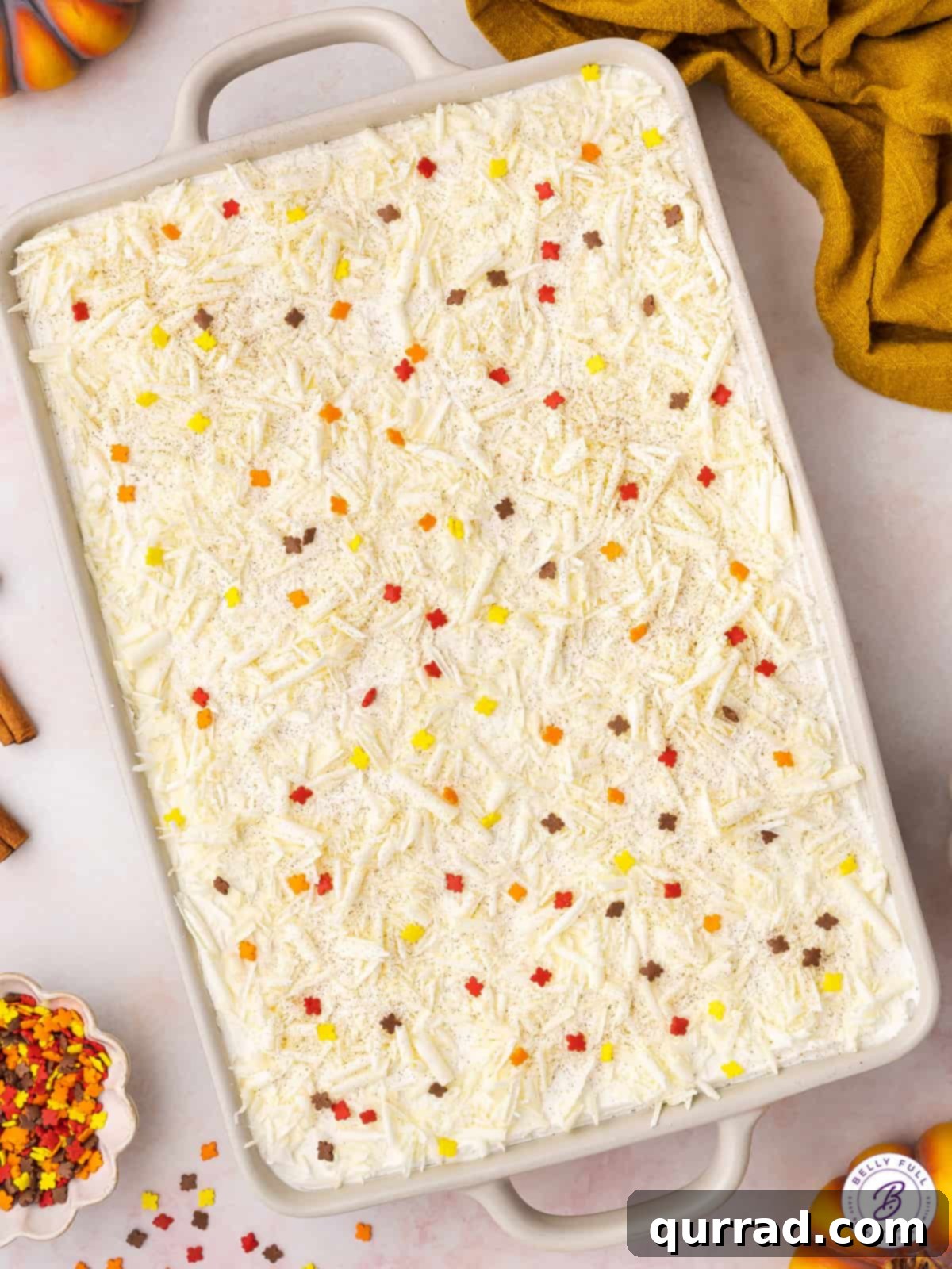 No-Bake Pumpkin Lasagna Ready to Chill An overhead shot showcasing the beautiful layers of a finished no-bake pumpkin dessert lasagna in a baking dish, ready for chilling.