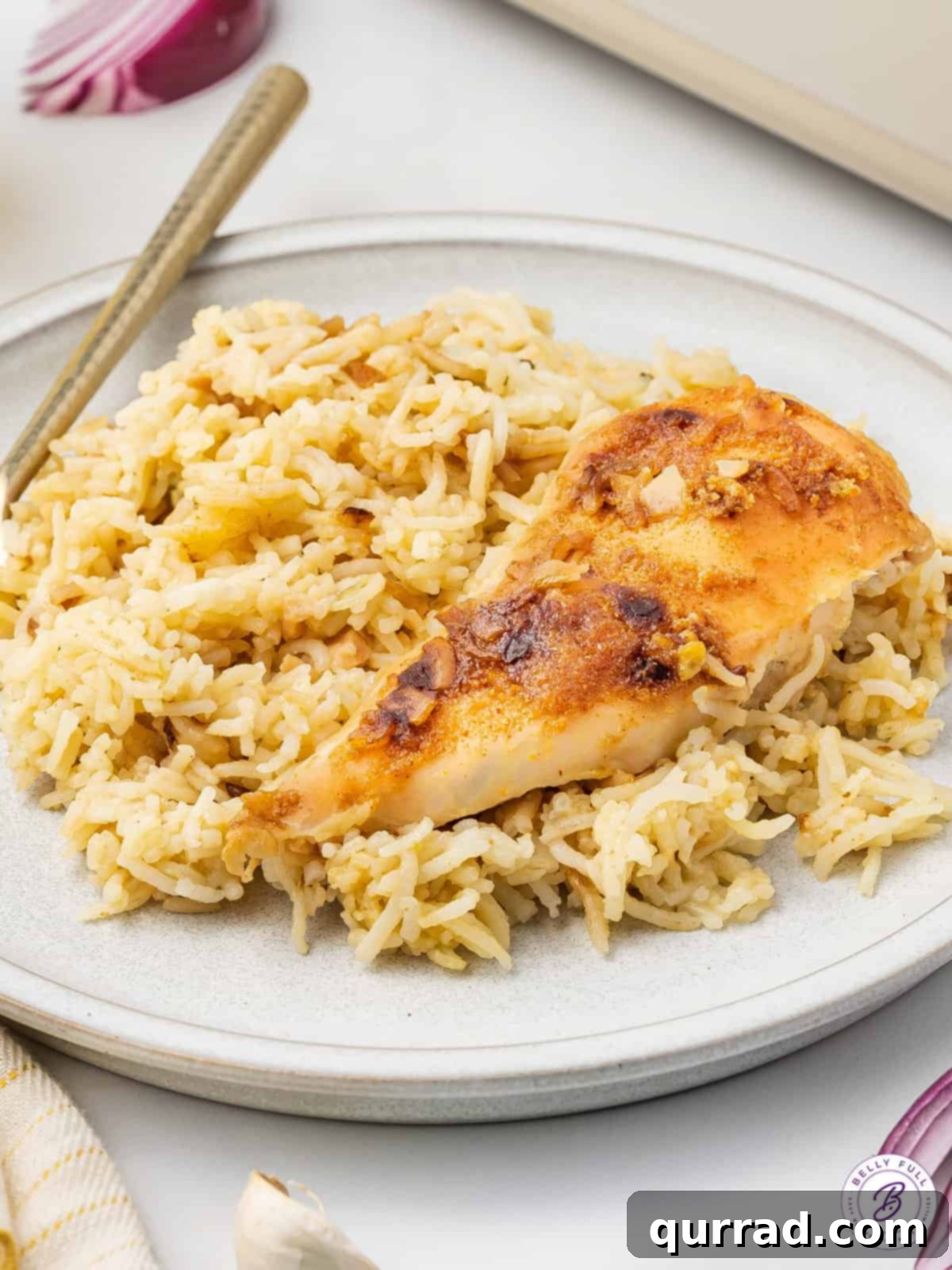 Angled view of a plate of No-Peek Chicken and Rice Casserole, garnished with fresh herbs, ready to be enjoyed.