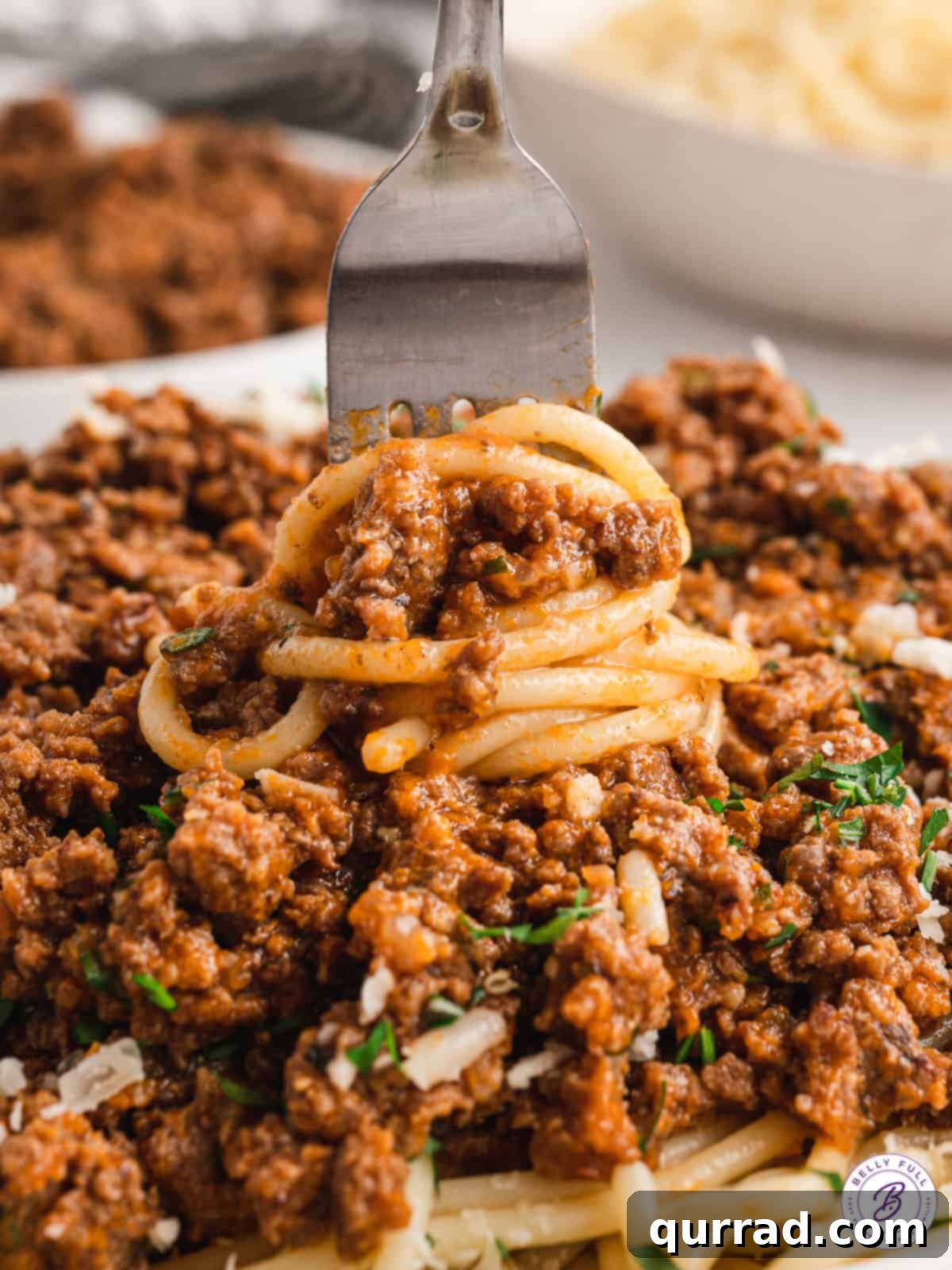 Savor the moment: a forkful of spaghetti and Magic Meat Sauce, a culinary delight. A fork expertly twirling spaghetti noodles coated in rich Magic Meat Sauce, ready to be enjoyed.
