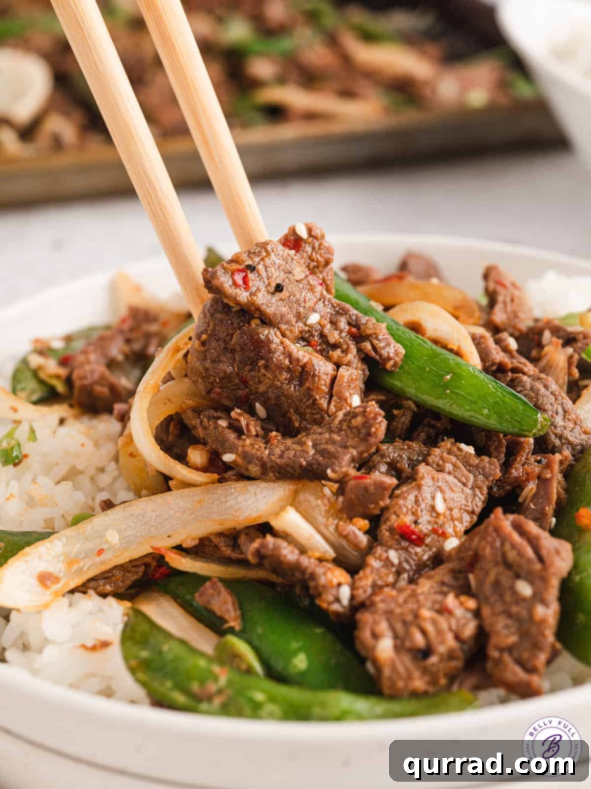 One-Pan Korean BBQ Beef 6 Chopsticks in a plate of Korean beef bulgogi over rice with vegetables