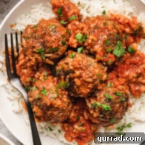 Overhead view of porcupine meatballs on a plate of rice