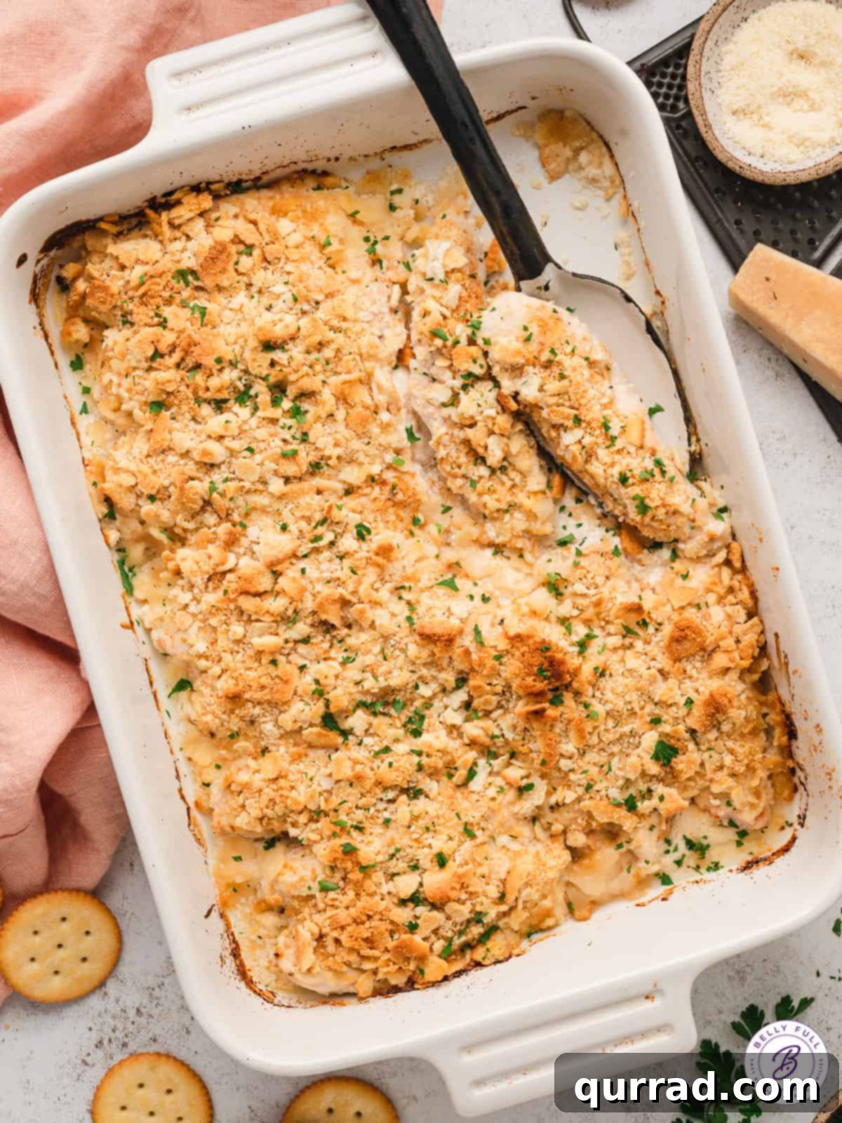 Overhead view of a casserole dish of perfectly baked Mayo Ritz Cracker Chicken, showcasing its golden-brown, crispy topping and creamy interior.