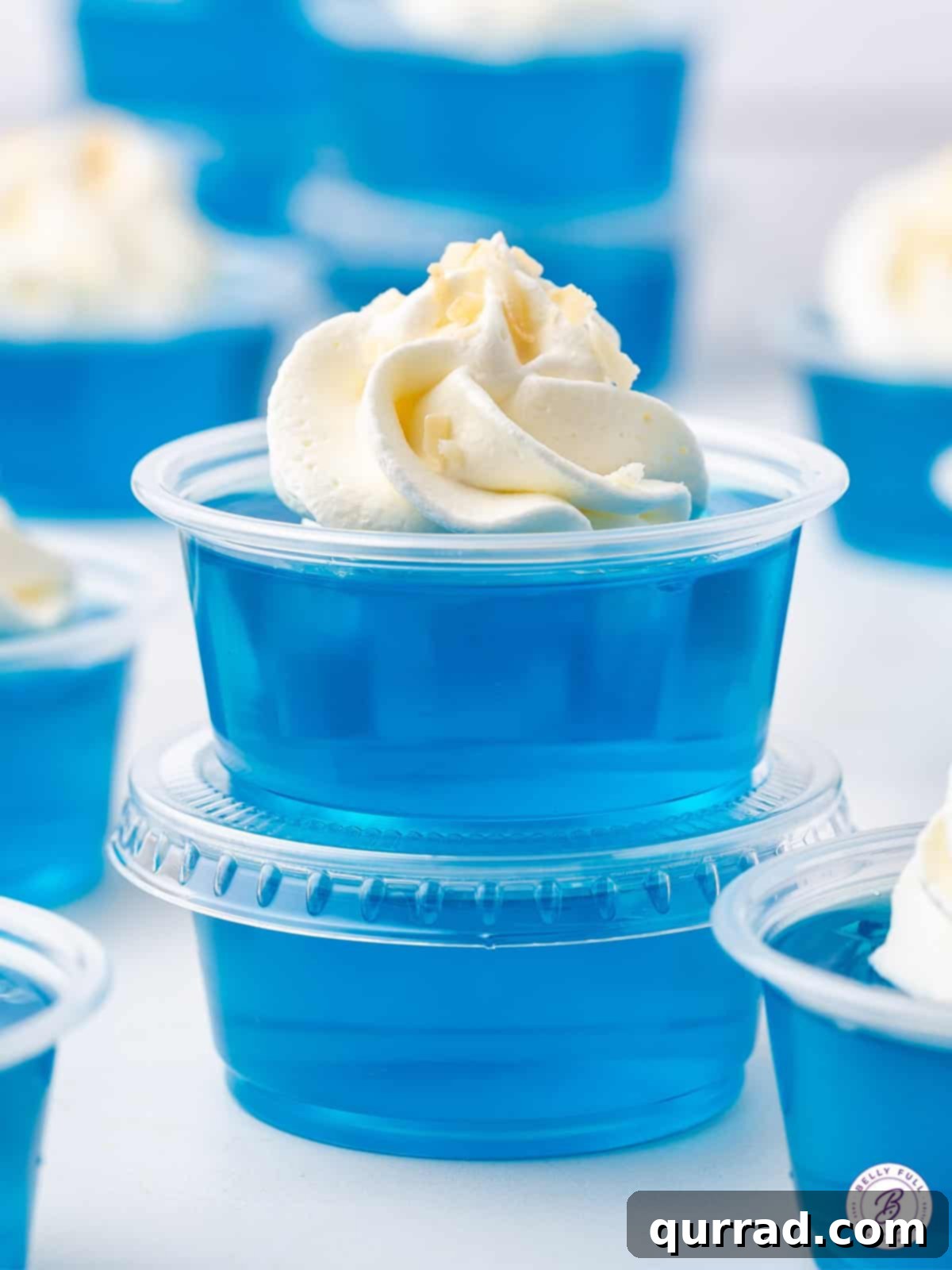 Jack Frost's Shimmering Shooters 2 Stack of 2 Jack Frost Jello Shots topped with whipped cream and toasted coconut flakes
