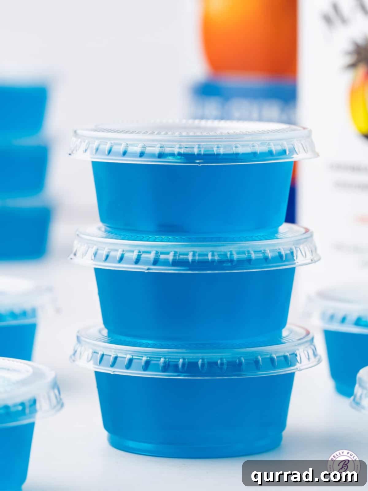 Jack Frost's Shimmering Shooters 3 Stack of 2 blue jello shots in plastic cups with lids