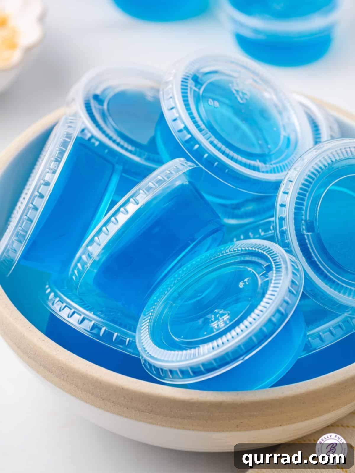 Jack Frost's Shimmering Shooters 4 Bowl of blue jello shots with lids on, ready for the fridge