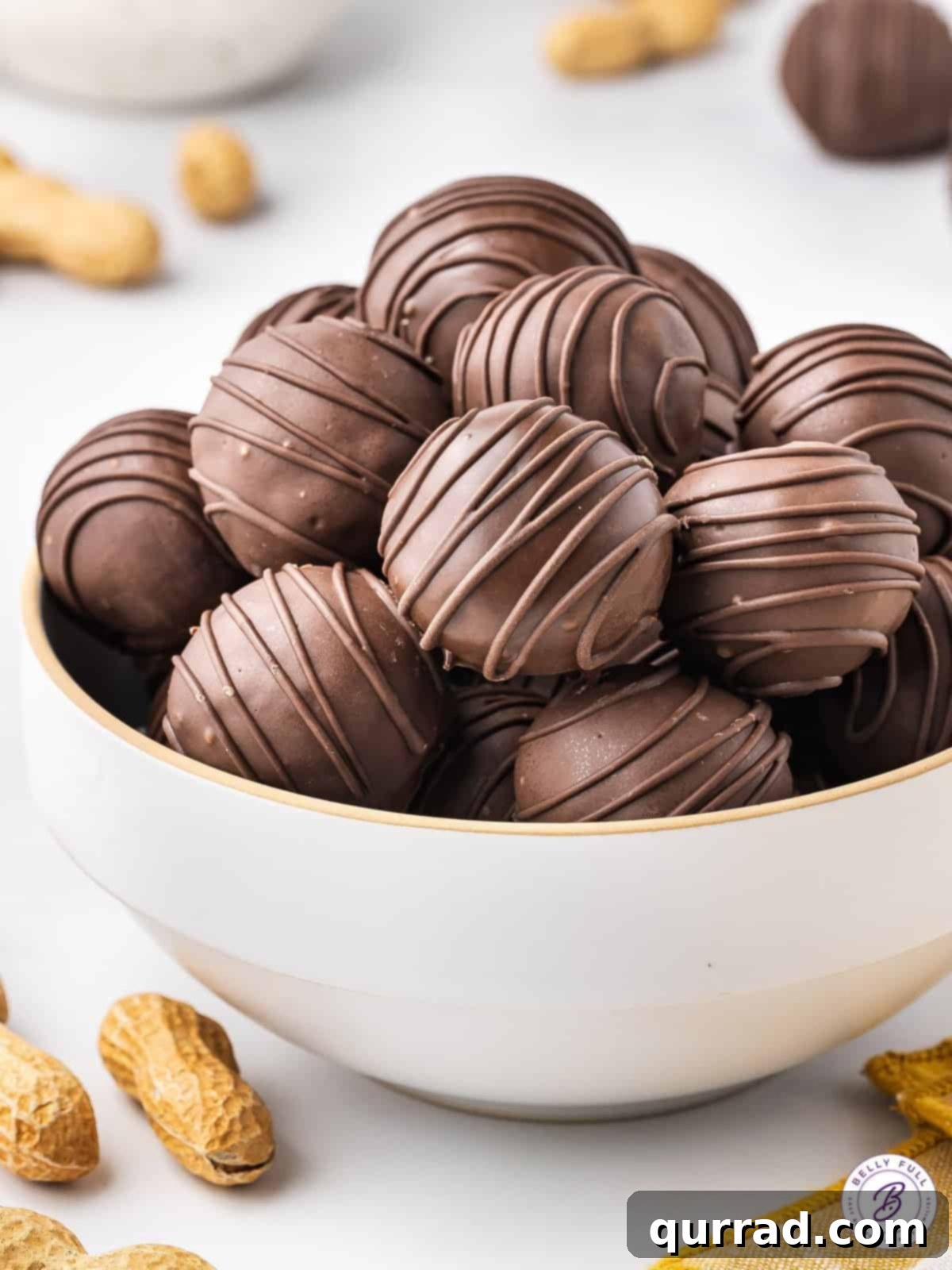 A white bowl filled with peanut butter balls with Rice Krispies