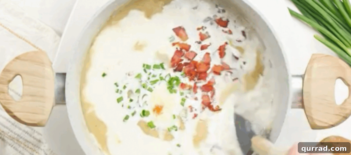 Creamy Roasted Potato Soup 7 Adding half-and-half, cream cheese, Parmesan, scallion greens, and reserved bacon to the blended soup, stirring to combine.