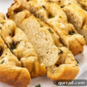 Close up of slices of slow cooker focaccia, showing its golden crust and dimpled texture.