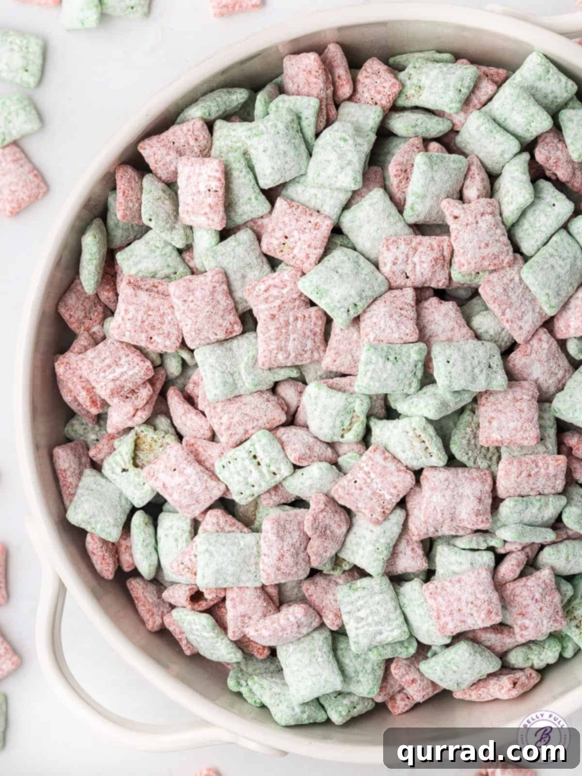 Santa's Sweet Snow Bites 3 Red and green Christmas muddy buddies filling a bowl, ready for serving