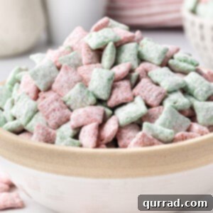 Christmas Muddy Buddies piled high in bowl