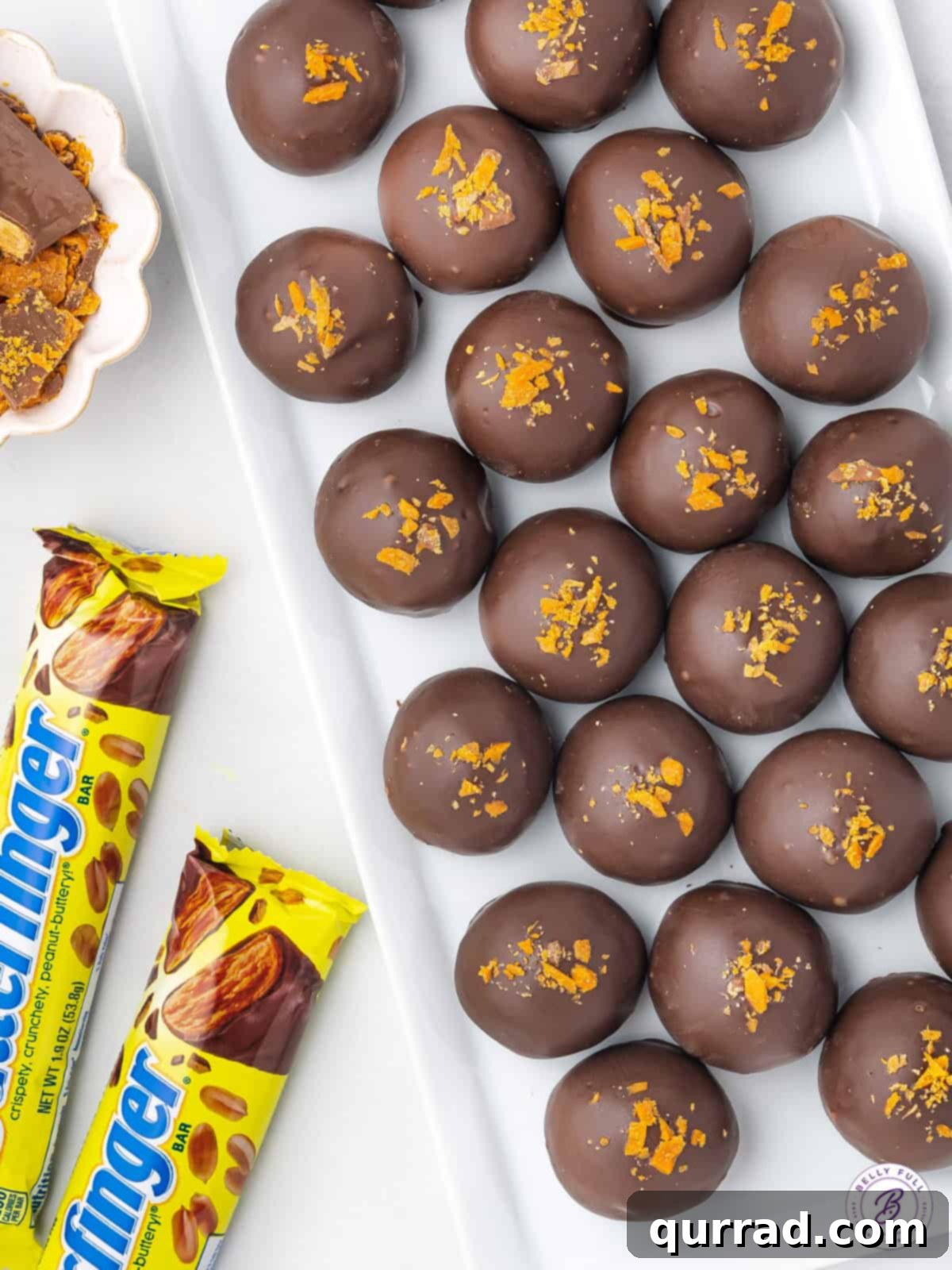 A selection of tempting Butterfinger Truffles arranged neatly on a tray, showcasing their consistent size and the generous chocolate coating, ready for serving.