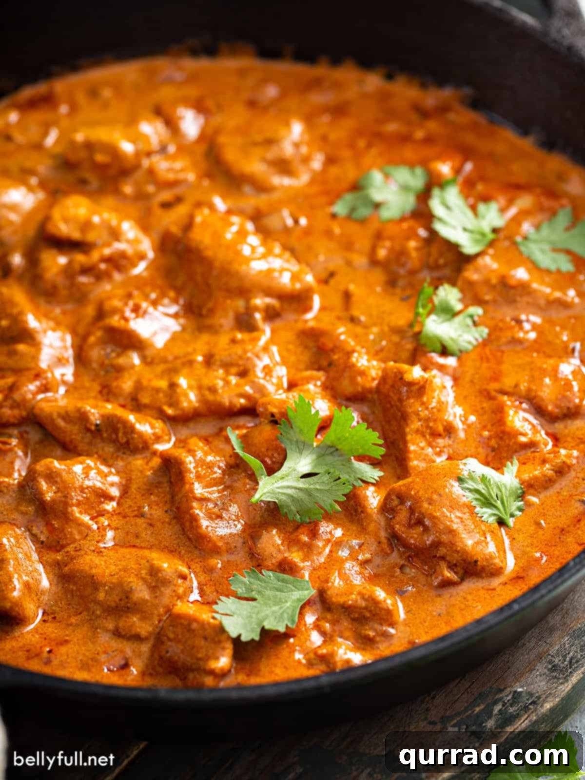 tikka masala in skillet garnished with cilantro leaves