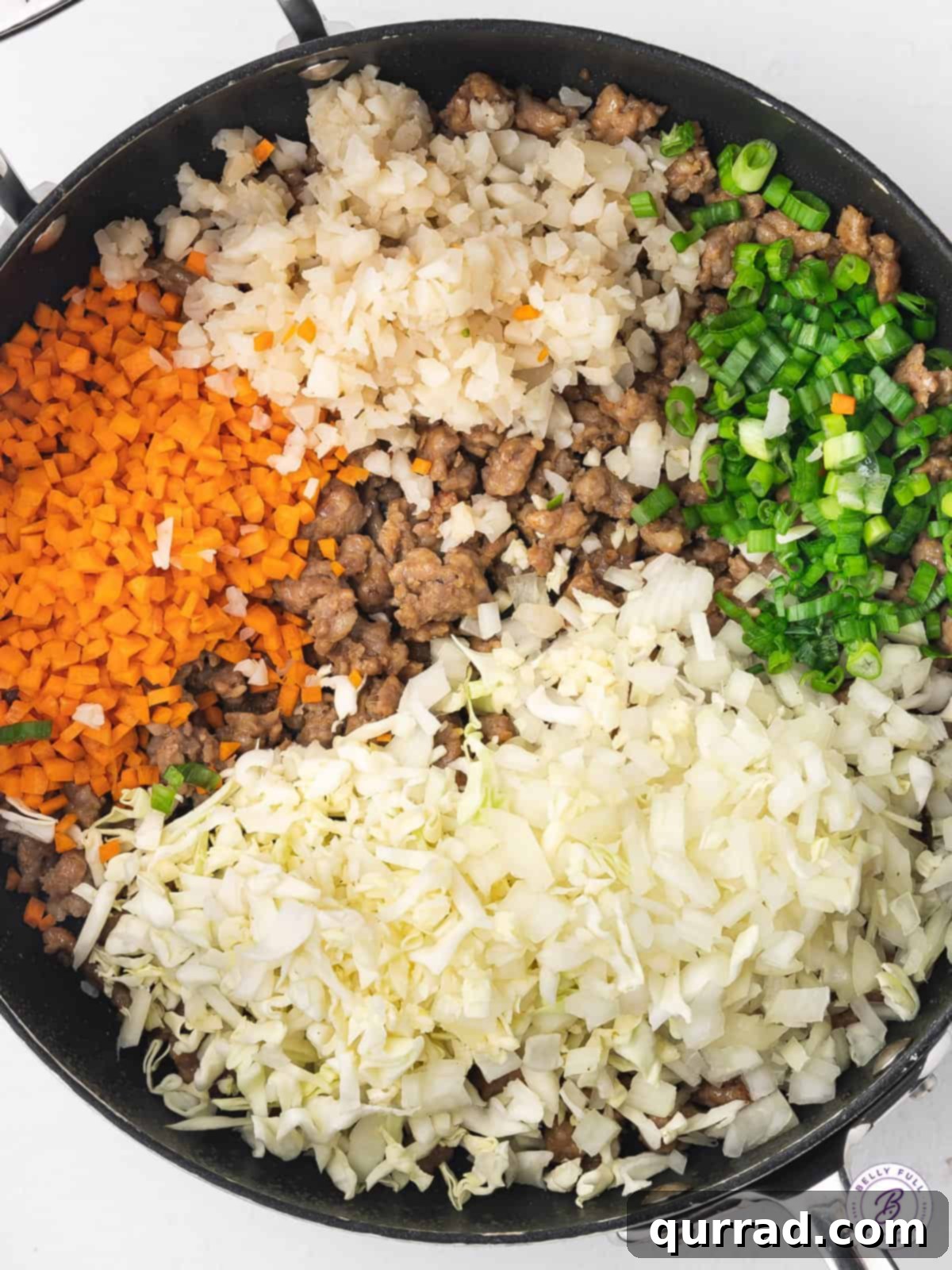 This lumpia recipe features a ground pork and water chestnut filling in a thin wrapper that's fried to perfection. Pork lumpia filling ingredients simmering in a pan.