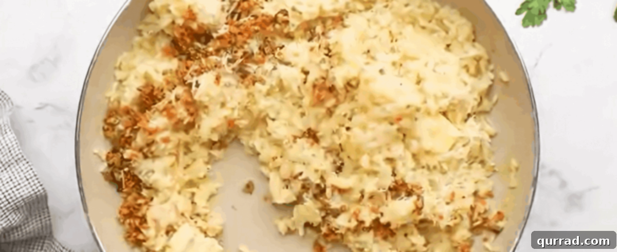 Crispy Golden Arancini 5 Cooked risotto, combined with sautéed vegetables, grated Parmesan cheese, salt, pepper, and melted butter, spread on a baking sheet to cool.