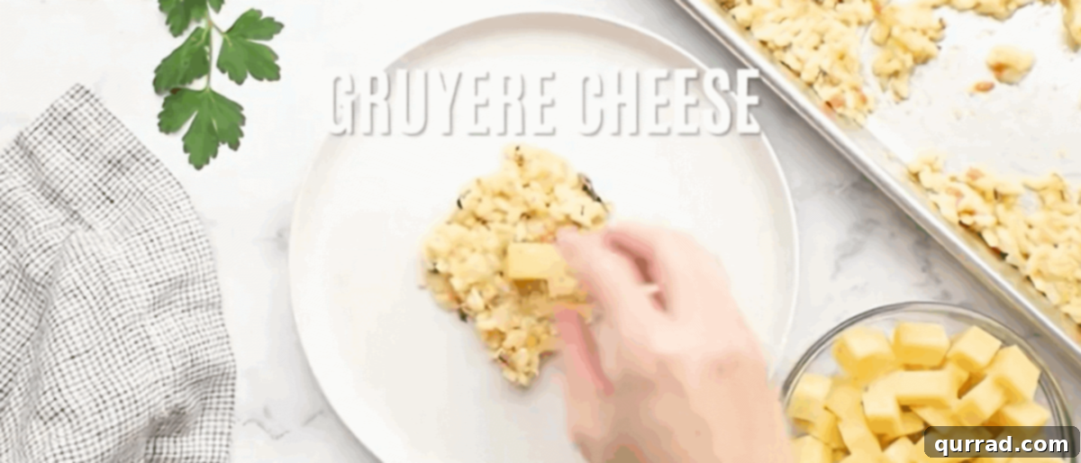 Crispy Golden Arancini 6 Hands carefully shaping a portion of cooled risotto around a small cube of chilled Gruyère cheese, forming a perfect round arancini ball.
